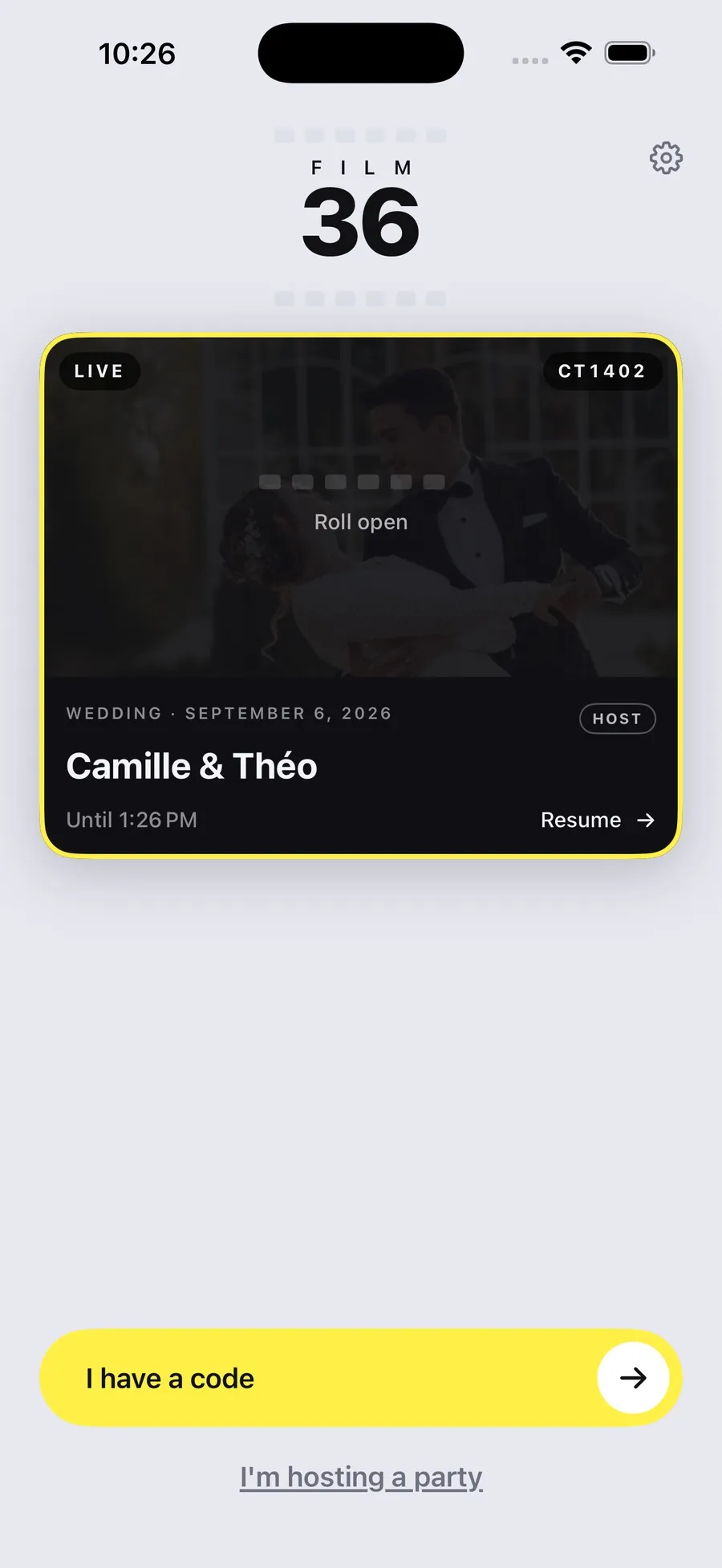 The Film 36 home screen during a live party, the wedding card outlined in yellow with the roll open, the entry code and a resume button